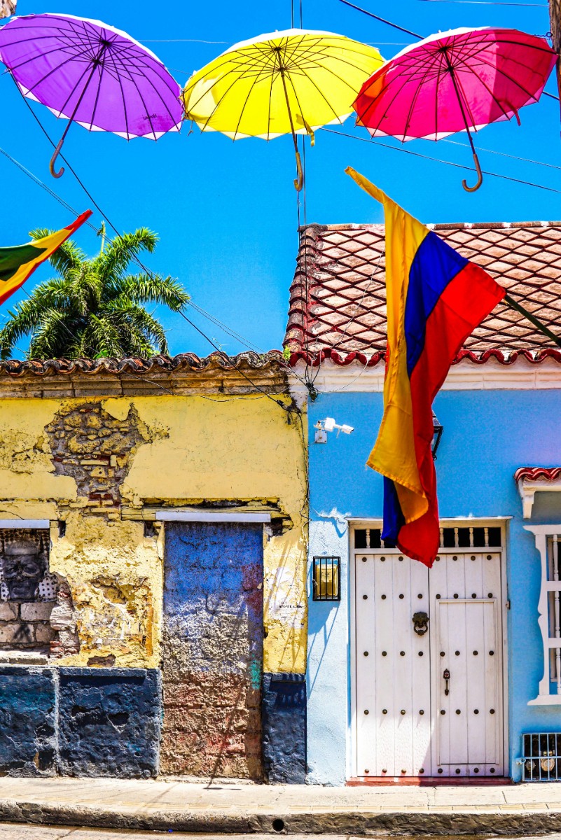 Overhead umbrellas forming a colourful street canopy in Cartagena, seen on a Panama Canal cruise