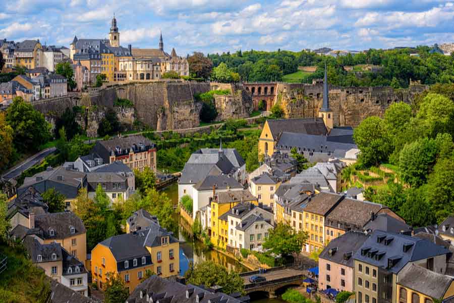 Historic Luxembourg City with colourful buildings, fortifications and green valley views
